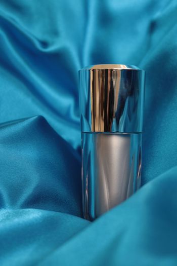 Close-up of lipstick on blue fabric