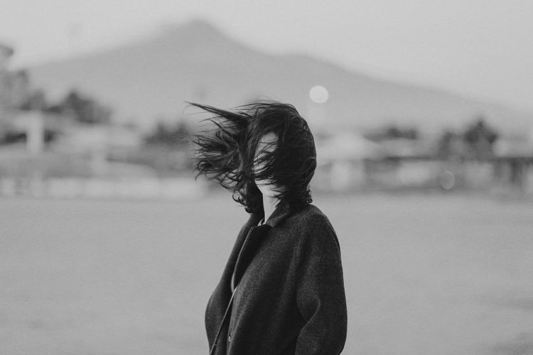Girl on a windy day with hair on her face