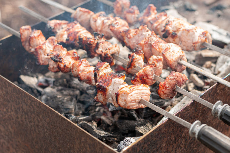 Marinated shashlik preparing on barbecue grill over charcoal. shish kebab popular in eastern europe