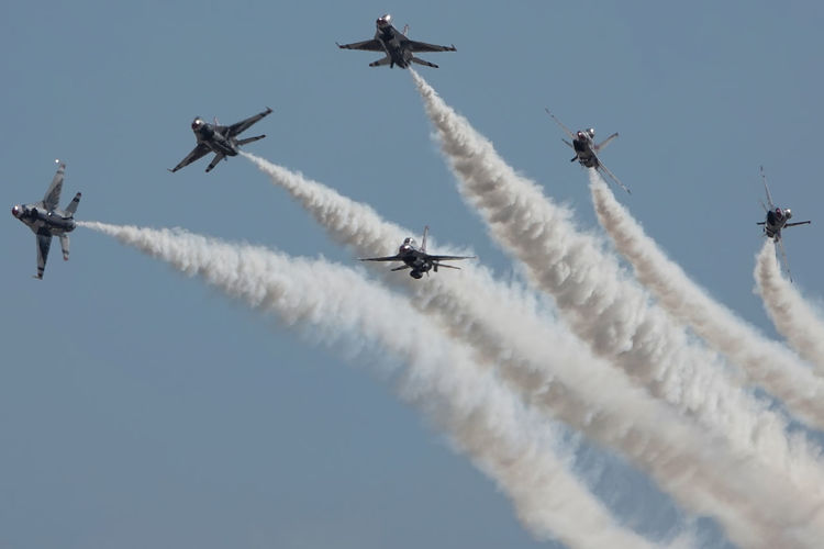 Low angle view of usaf thunderbirds in delta burst maneuver at airshow