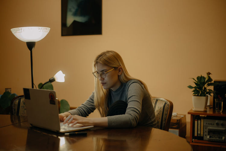 A young woman using a laptop at home. online shopping during pandemic.