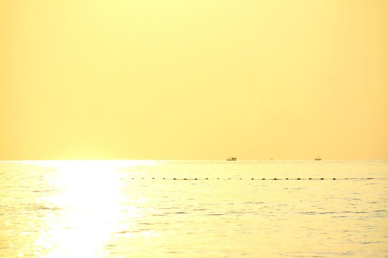 Scenic view of sea against clear sky during sunset