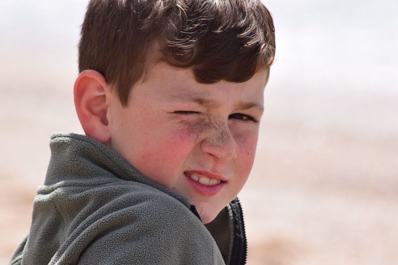 Close-up portrait of boy at beach
