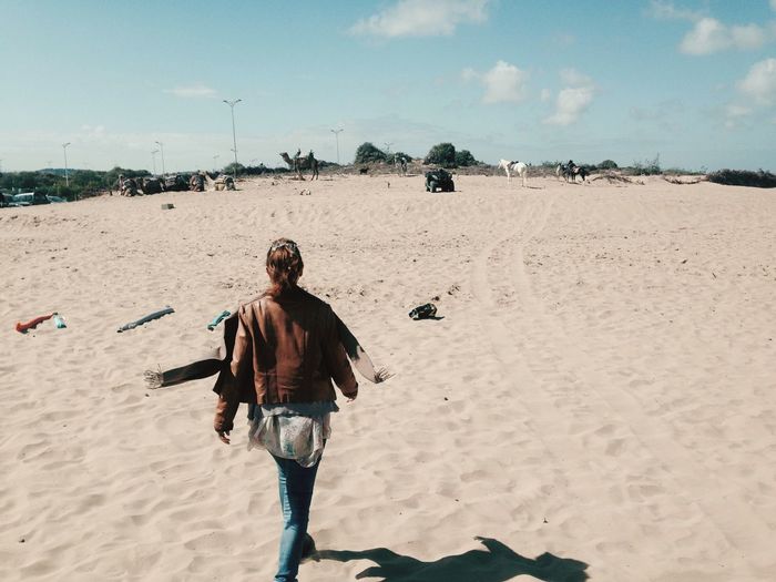 Full length of young woman walking on beach
