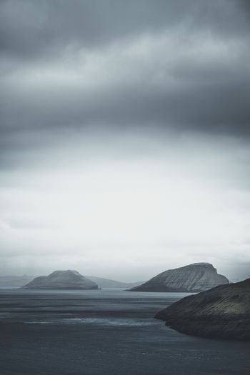 Scenic view of sea and mountains against sky