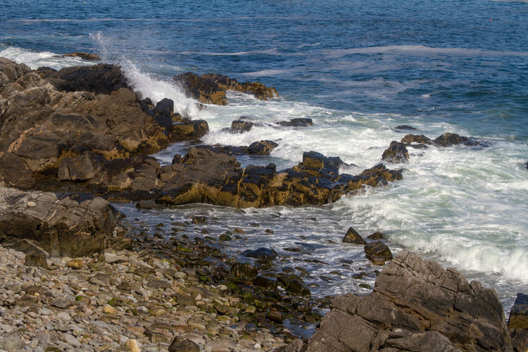 Scenic view of sea, waves and rocks 