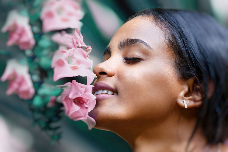 Close-up of woman with pink flowers