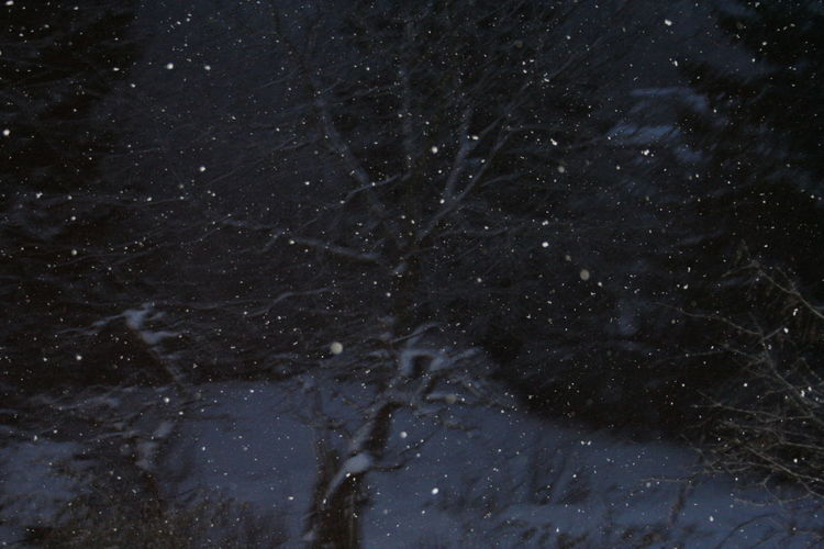 Full frame shot of snow against sky at night