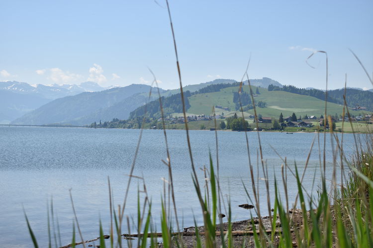 Scenic view of lake and mountains against sky