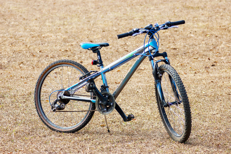 A generic bicycle on stand in an open field