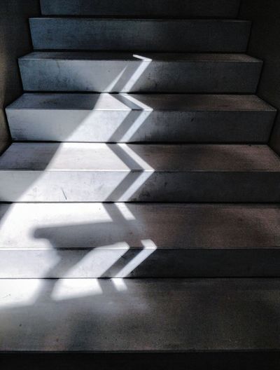 High angle view of light and shadow on concrete staircase