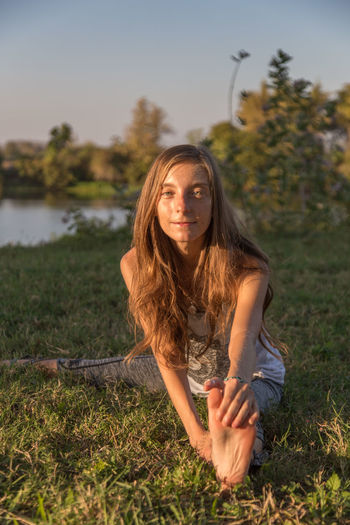 Portrait of young woman on field