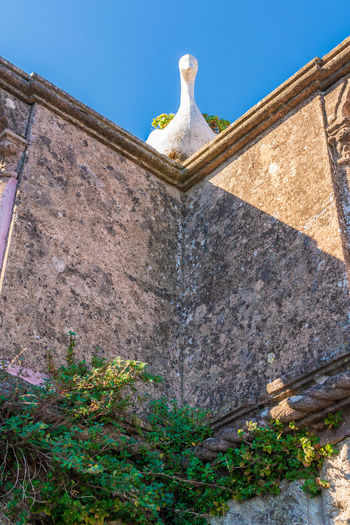 Low angle view of statue against blue sky