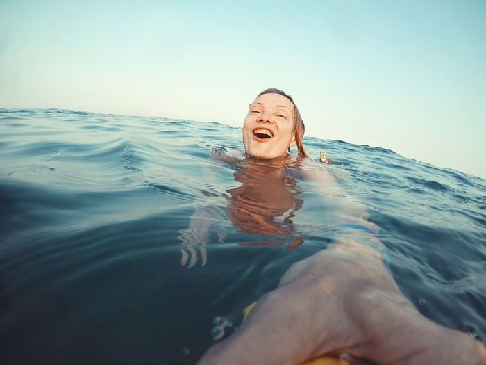 Portrait of smiling woman swimming in the sea