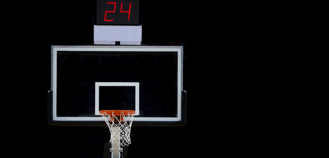 Low angle view of basketball hoop at night
