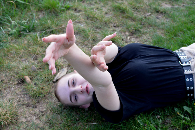 Portrait of funny  girl, lying on field. 