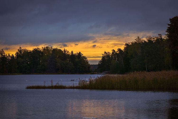 Scenic view of lake against sky during sunset