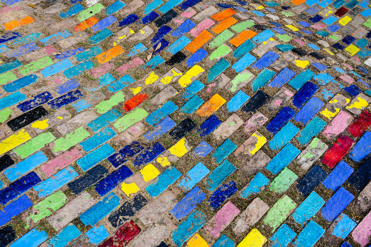 Top view on pieces of multicolored ceramic tiles decorated in garden.old pavement of tiles textured 