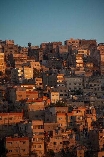 High angle view of buildings in city against clear sky