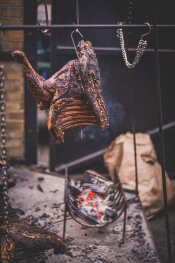 Close-up of meat hanging over burning charcoal at shop