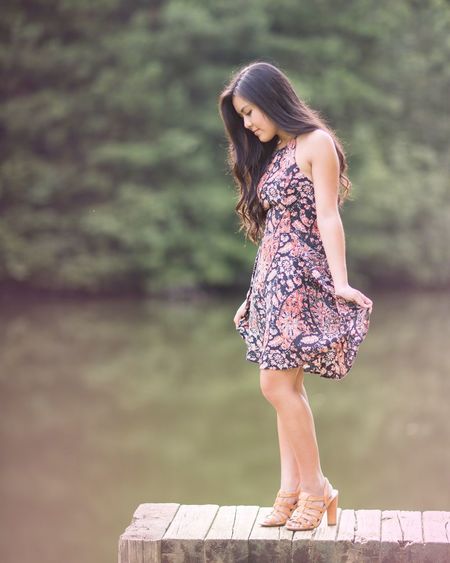 Side view of a young woman standing on pier