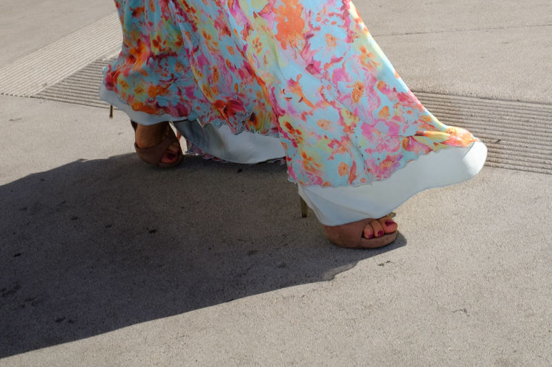 Low section of woman walking on street