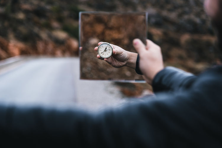 Closeup view of clock in a mirror reflection