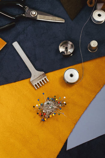 Tailor workplace accessories. close up view of the eco leather and sewing equipment