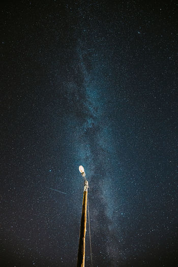 Low angle view of street light against starry sky