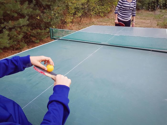 People playing table tennis outdoors