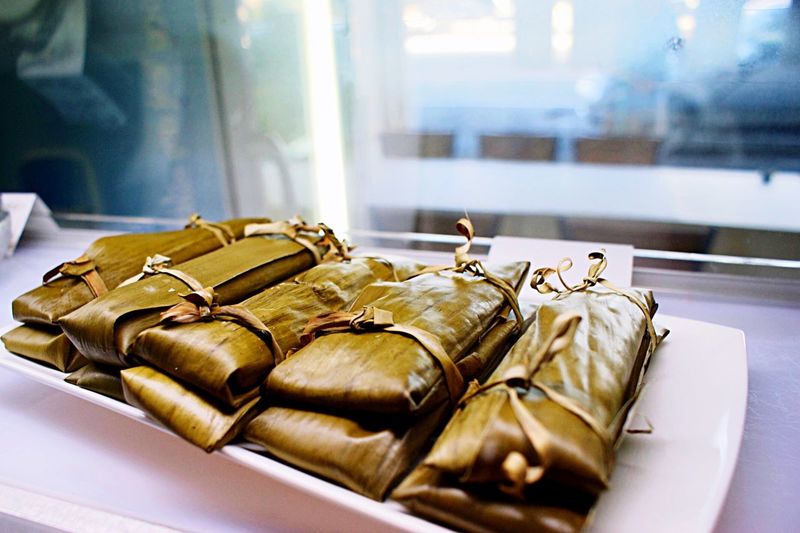 Close-up of food wrapped in banana leaves on tray