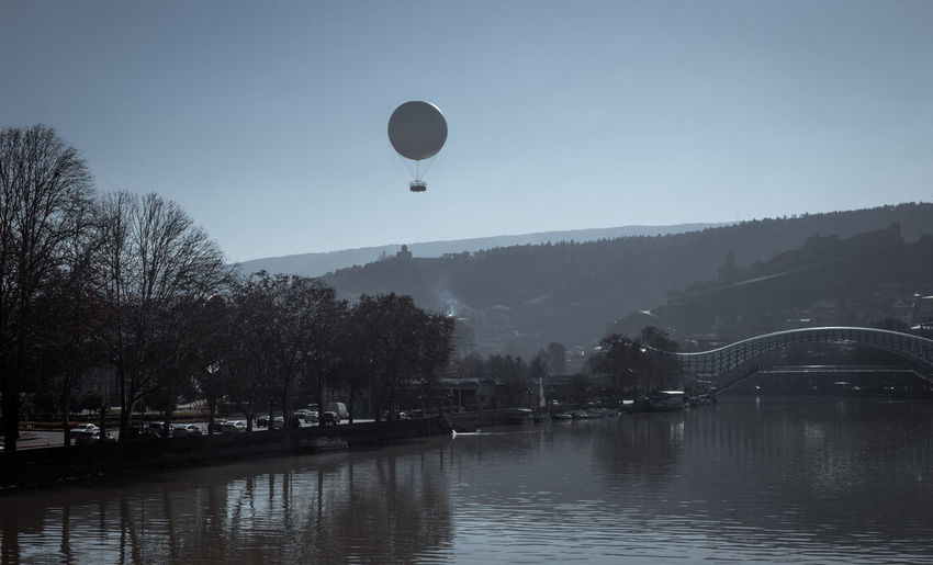 View of hot air balloon over river against sky