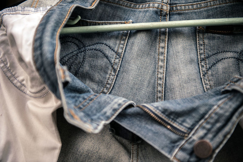 Close-up of jeans hanging from coathanger
