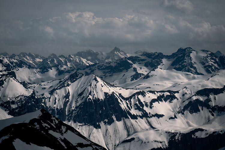 Aerial view of snowcapped mountains against sky