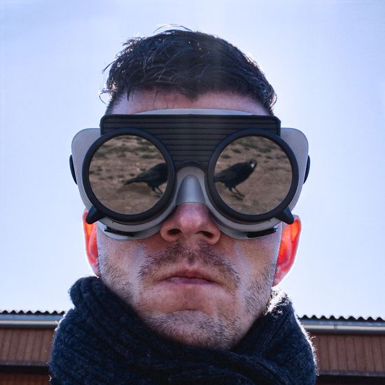 Close-up of man wearing eyeglasses with reflection