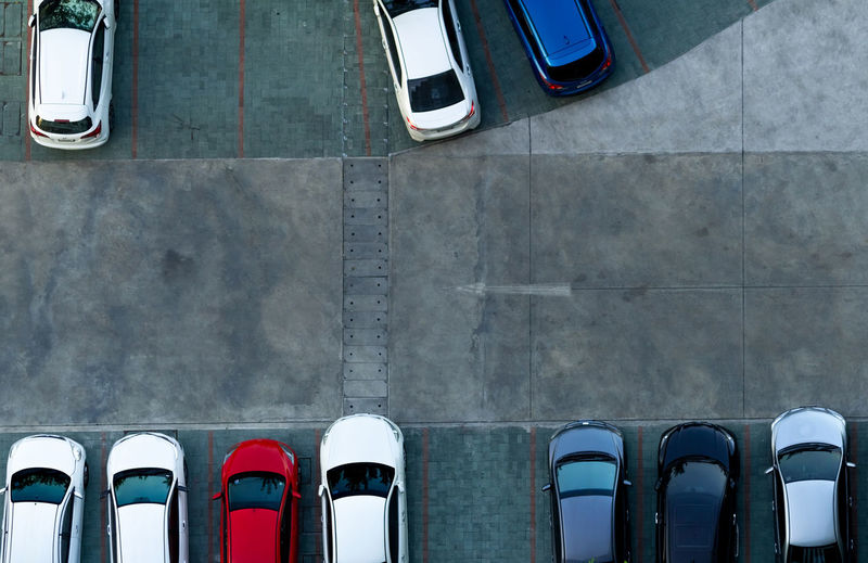 Top view concrete car parking lot. aerial view of car parked at car parking area of apartment. 