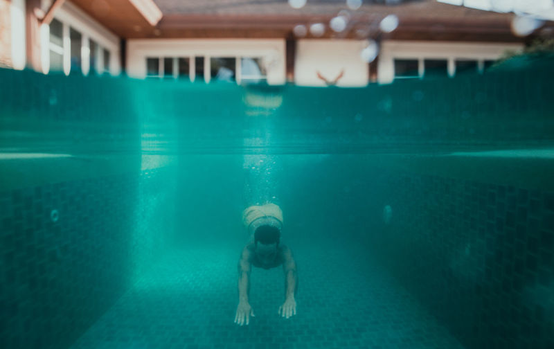 Full length of boy swimming in pool