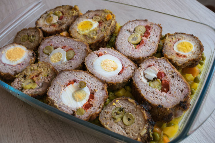 Meat roll stuffed with egg, olives, ham and pepper