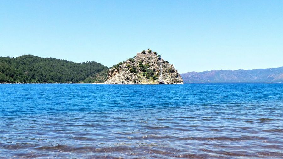 Scenic view of sea against clear blue sky