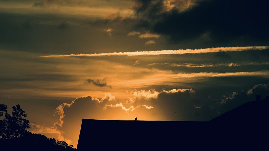Low angle view of dramatic sky during sunset