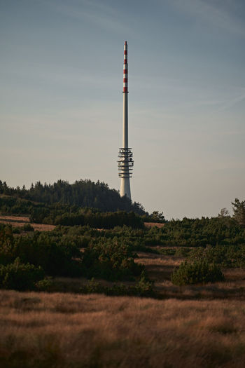 Tower on field against sky