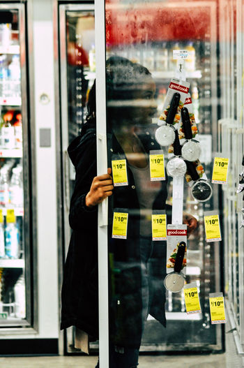 Man standing by window at store