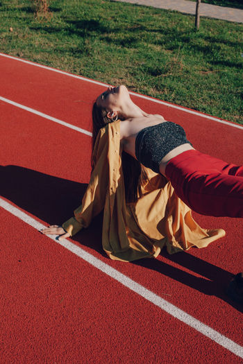 Young woman exercising on running track