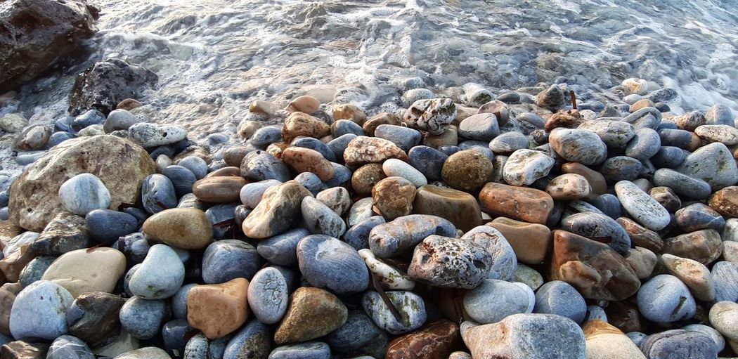 High angle view of pebbles on shore
