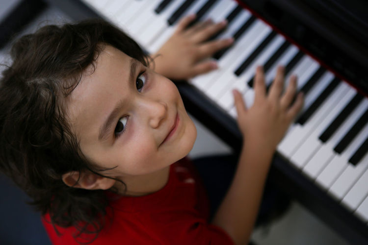 Portrait of cute boy playing piano