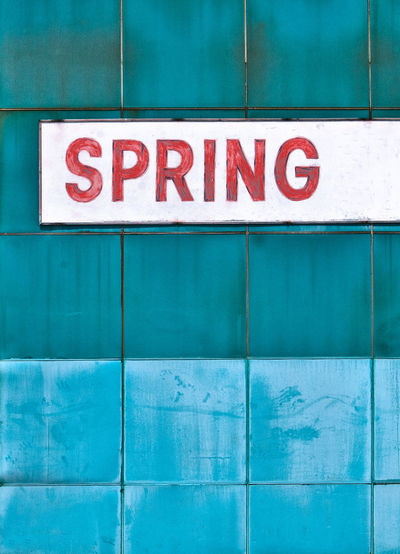 Spring text on blue wall