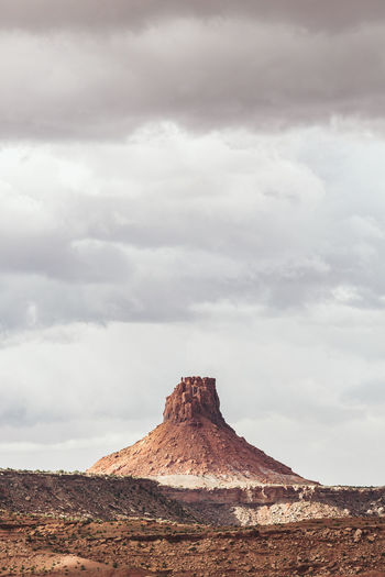 Elaterite butte seen from the south under rain clouds in the maze utah
