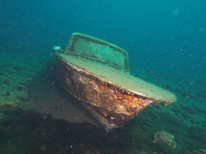 Aerial view of abandoned boat in quarry lake