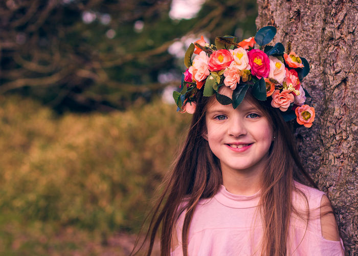 Portrait of smiling girl wearing flowers