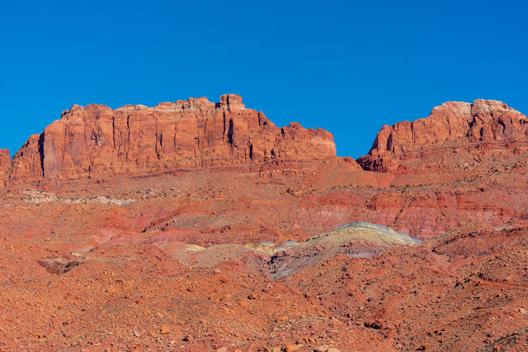 Low angle landscape of barren red stone hillside at marble canyon in arizona
